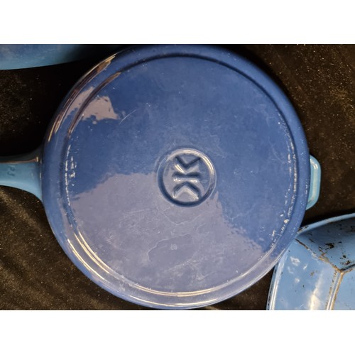 259 - A set of three cast iron blue enamelled pans, including a vintage French made Le Creuset griddle pan... 