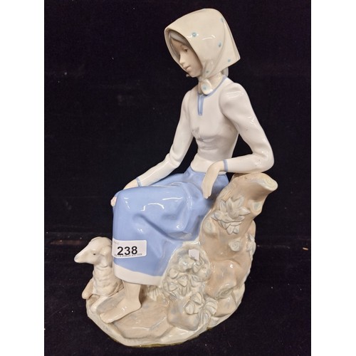 238 - A very large porcelain figure of an elegant lady with lamb by Rex Valencia, hand painted in soft pas... 