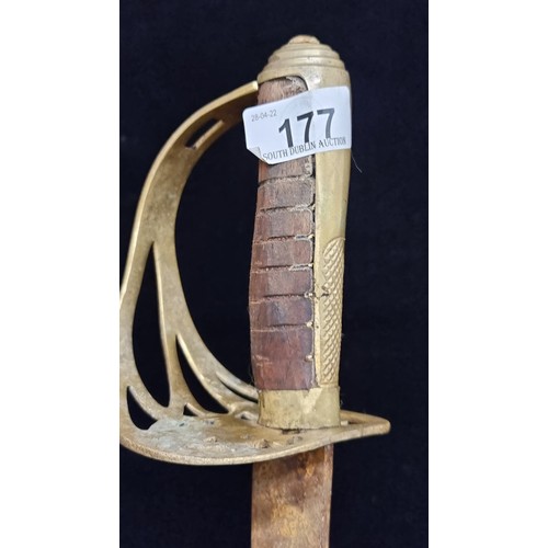 177 - An antique military sword with a wooden handle and brass hilt. With pierced hand guard.