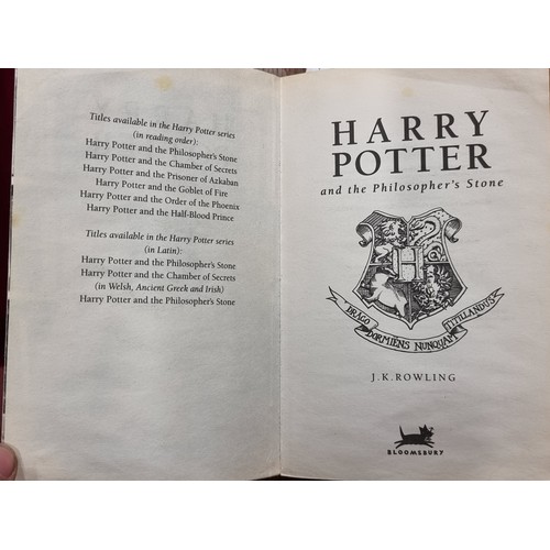 209 - A first edition paperback copy of the book Harry Potter and the Philosopher's Stone by J. K Rowling.... 