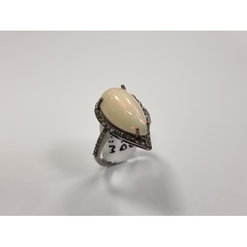 331 - A beautiful Large natural Opal and Diamond ring with lots of colur with reds and green catching the ... 