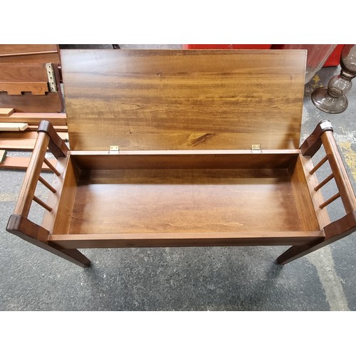 337 - A contemporary wooden storage bench. With railed ends and hinged lid. for storage below H47 cms x L9... 