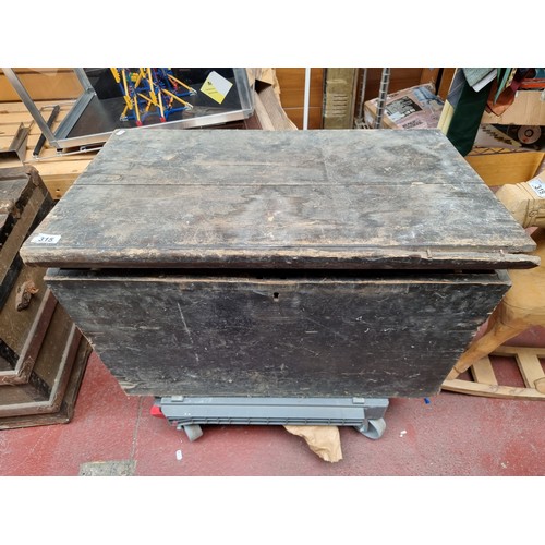 315 - A large vintage wooden storage chest with a plethora of cast iron and brass hardware and fittings in... 