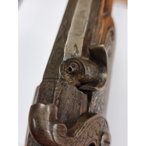 742 - Star Lot : An antique original  wooden handled flint lock pistol, with brass handled fittings. Lengt... 