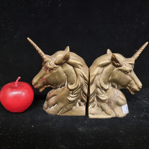 130 - A pair of heavy brass bookends in the form of unicorns. Charming pieces with lovely detail.