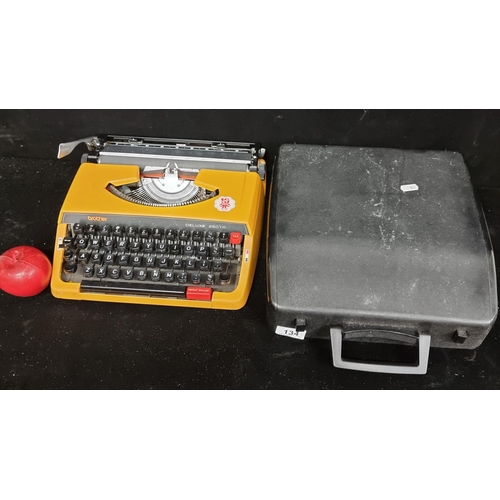 134 - A vintage 1970s Brother Deluxe 250TR Typewriter with a fantastic mustard finish. Set into it's origi... 