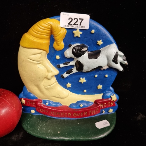 227 - A heavy cast metal standing plaque depicting a nursery rhyme scene: ''The Cow Jumped Over the Moon''... 