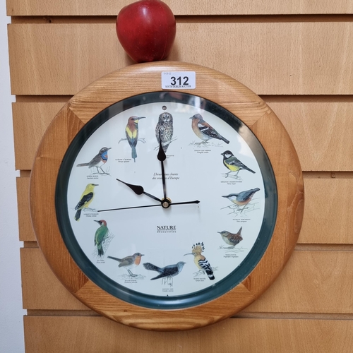 312 - A wooden framed wall hanging clock by Nature Découvertes, that features local garden birds in stead ... 