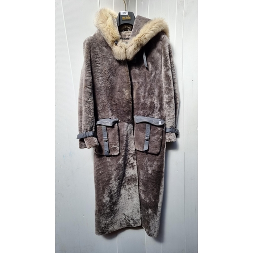 372 - A very attractive contemporary style ladies long coat in faux fur. With an oversized hood and eskimo... 