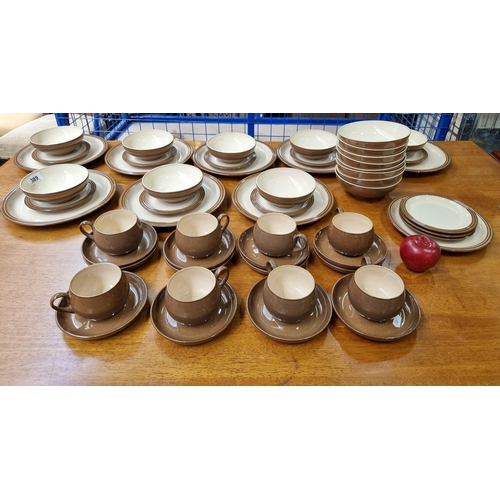 389 - Fifty five pieces of Denby ceramic table ware in a beautiful mottled brown glaze with cream interior... 