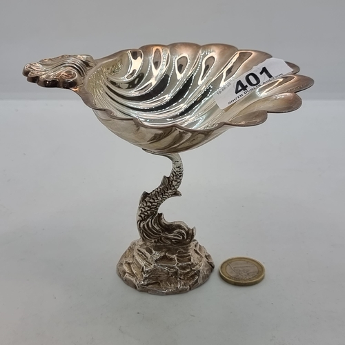 401 - Star Lot: A stunning Irish silver shell design dish, mounted on a footed base supported by Mythical ... 