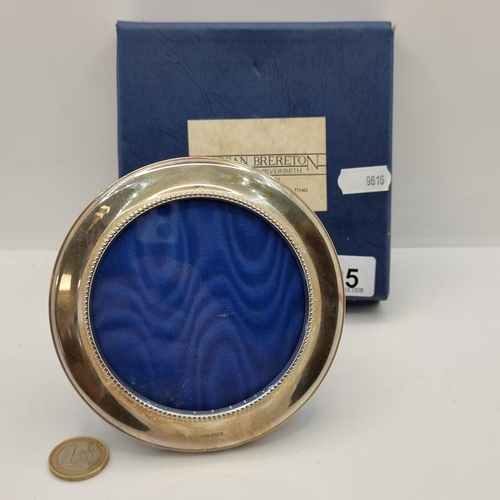 405 - A sterling silver glazed circular photo frame, hallmarked Birmingham and makers mark state 