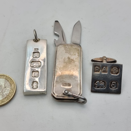 408 - A collection of three hallmarked sterling silver items, including a silver ingot, pen knife and cuff... 