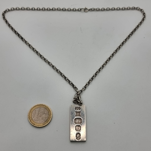 409 - An interesting sterling silver ingot, hallmarked Birmingham. With chain length: 46cm and a total wei... 