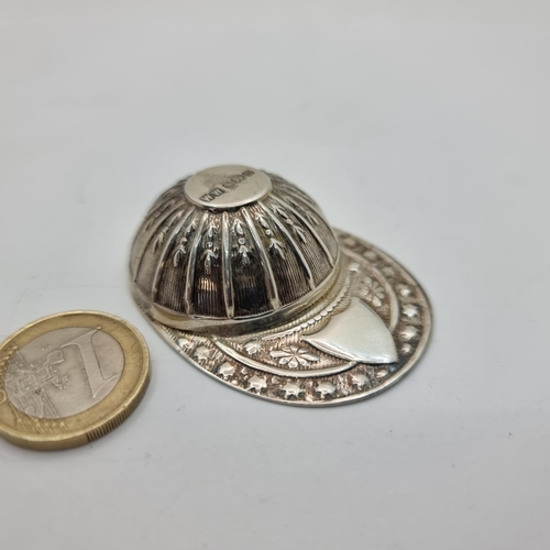 412 - A sterling silver jockey cap with blank cartouche to rim. Hallmark is Sheffield, makers mark W.W She... 