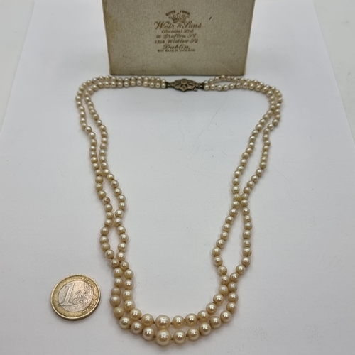 43 - A beautiful vintage two row graduated Pearl necklace, with sterling silver Diamond floral clasp. Len... 