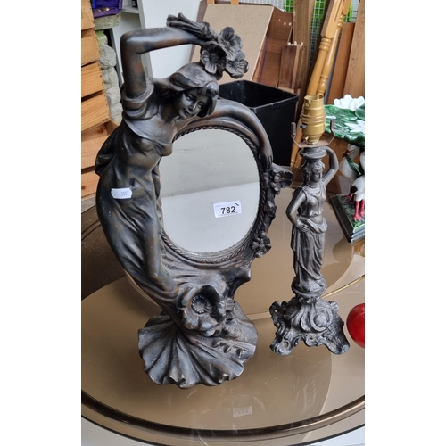 782 - Two stylish decorative items comprising of a lovely freestanding mirror, set into a figural frame of... 