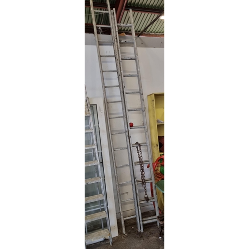 796 - Two very tall metal ladders with 14 and 12 rungs, perfect for reaching high places.