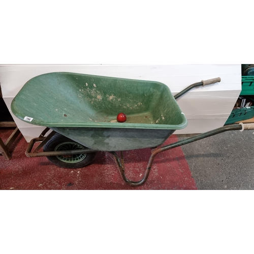 798 - A large green wheelbarrow.