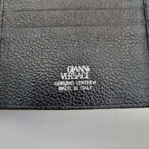 55 - A black leather wallet with a mark stating 
