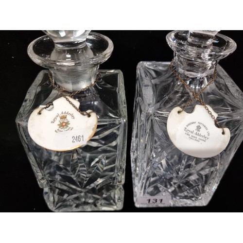 131 - A pair of heavy crystal decanters with deep fan cuts and large faceted stoppers, with fine bone chin... 