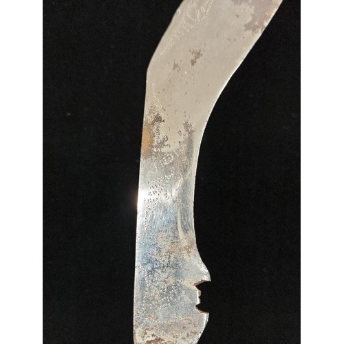 204 - A handsome and very large Kukuri knife. Fitted with a very ornately beaded scabbard and aluminium hi... 