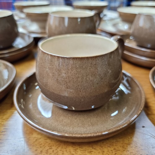 389 - Fifty five pieces of Denby ceramic table ware in a beautiful mottled brown glaze with cream interior... 