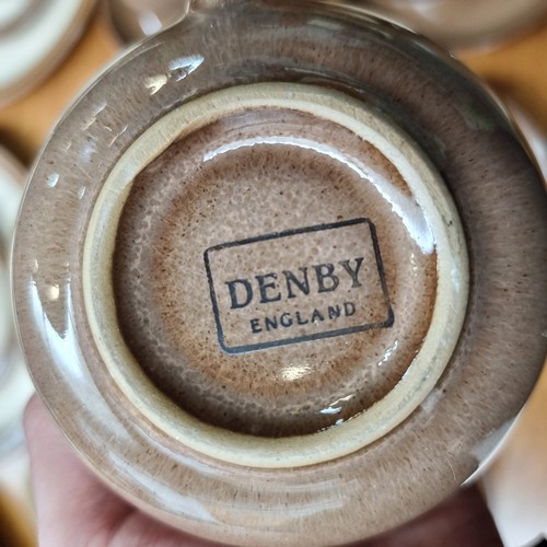 389 - Fifty five pieces of Denby ceramic table ware in a beautiful mottled brown glaze with cream interior... 