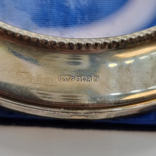 405 - A sterling silver glazed circular photo frame, hallmarked Birmingham and makers mark state 