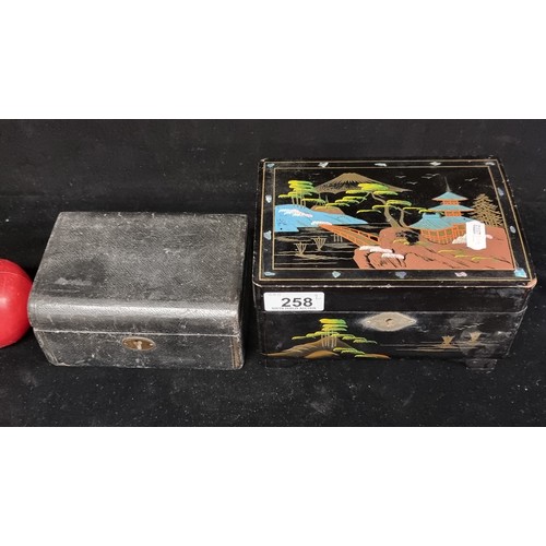 258 - Two vintage jewellery boxes including a Japanese black lacquer example with hand-painted pagoda scen... 