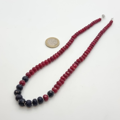 17 - A graduated Ruby and Sapphire necklace, with Sterling silver lobster clasp. Length of necklace: 45cm... 