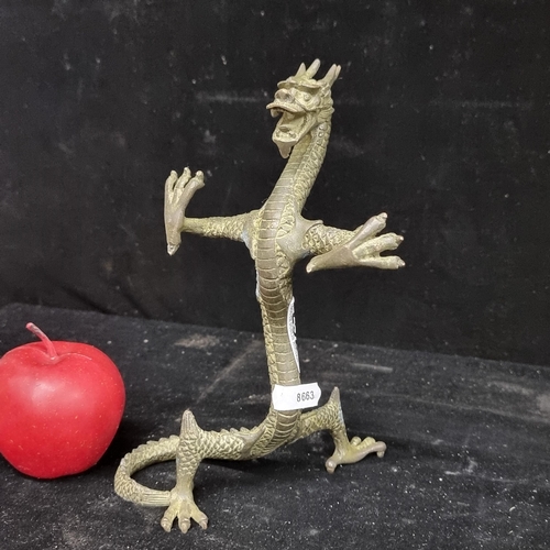252 - A striking Chinese bronze figure of a dragon in a powerful charging pose. A very expressive piece wi... 
