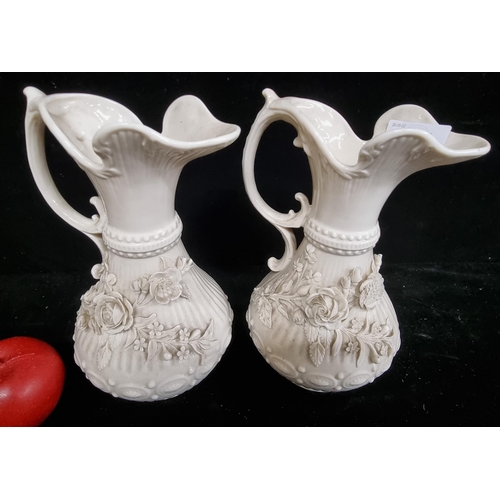 265 - A stunning pair of ornate vintage Belleek porcelain pitchers. Lavishly decorated with foliate curves... 