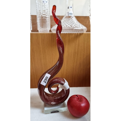 290 - A hand blown art-glass Murano sculpture in a spiral form with twisted top. In a ruby red tone with g... 