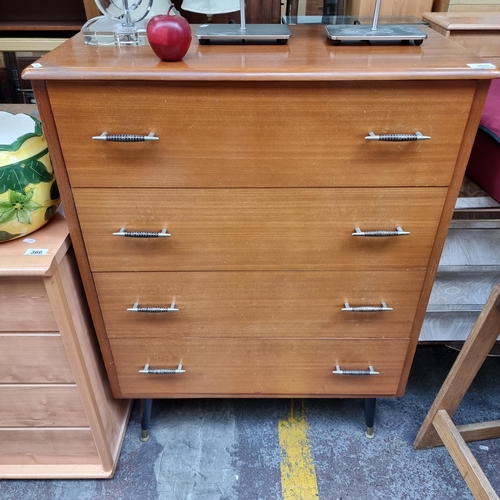 369 - A very stylish teak mid century chest of drawers with four drawers and metal pull handles, held on s... 