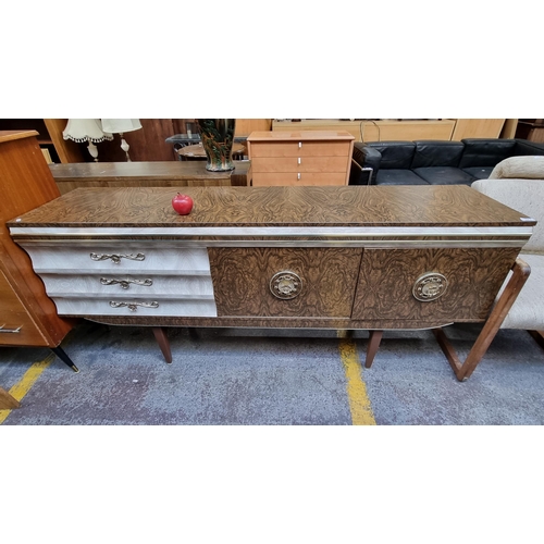 377 - A very large mid century modern side board featuring two cupboards and three drawers each with highl... 