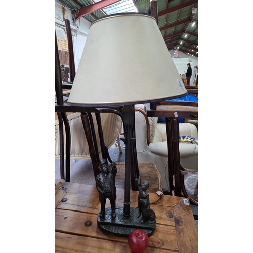387 - A Genesis fine arts table lamp with the bronze figures of a gentleman, a young boy and his dog.