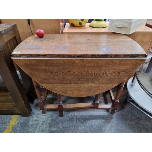 398 - A very handsome Edwardian oak gate leg drop leaf table with turned stretcher supports.