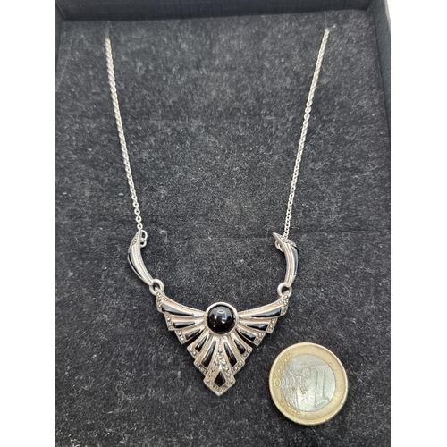 402 - A pretty Onyx and Marcasite fan style drop pendant. Length of necklace: 40cm.