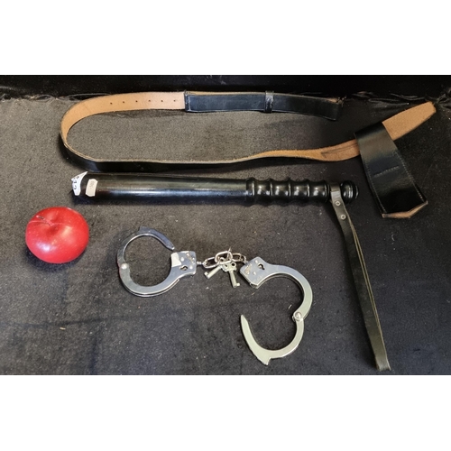 612 - A police baton and belt  pair of handcuffs with keys..