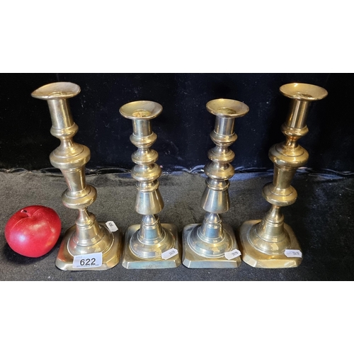 622 - Four beautiful brass candlesticks in a classic design.