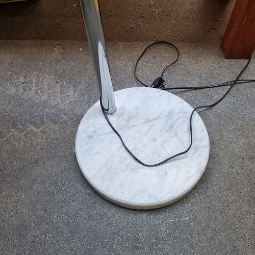 353 - A striking designer Italian standing light with a curved frame  in chrome and globe end held on a wh... 