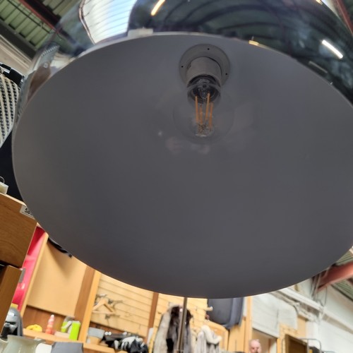353 - A striking designer Italian standing light with a curved frame  in chrome and globe end held on a wh... 