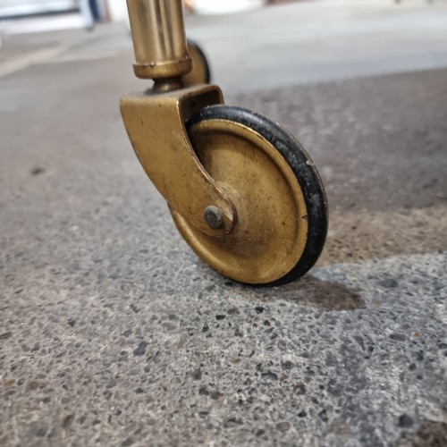 625 - A lovely two tiered chrome vintage drinks trolly with textured red tops, all held on castors.