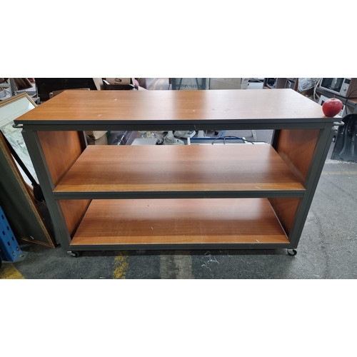 84 - A large heavy storage shelf with wood effect, handles to each side and casters to base. Mm: L 135cm ... 