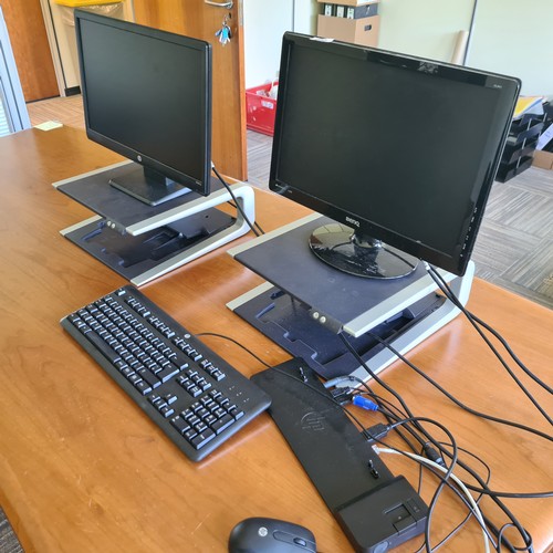 92 - Collection It equipment including 2 monitors, 2 monitor risers and a keyboard.  Located in the execu... 