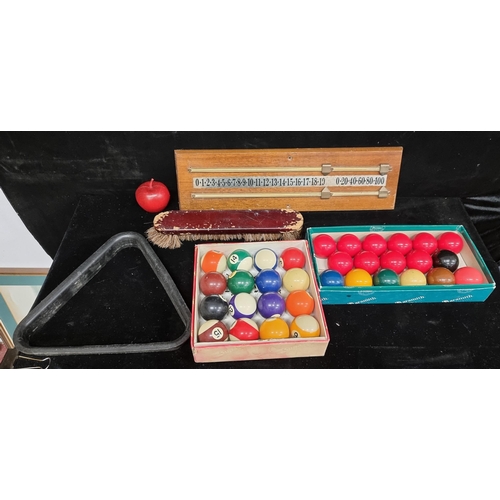 137 - A snooker table set including a rack, brush, a vintage snooker score board, snooker balls and pool b... 