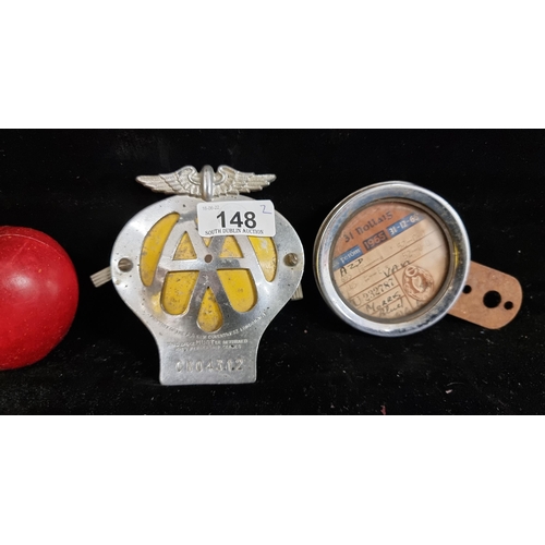 148 - Two car and automobile badges, including a vintage AA membership badge with a Desmo England tax disc... 