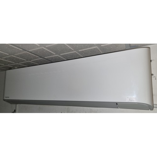 Star Lot Almost new Toshiba wall mounted air conditioner unit with a