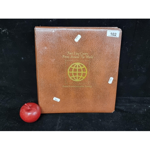 102 - A vintage stamp album with First Day Covers from around the world. Issued by a Postal Commemorative ... 